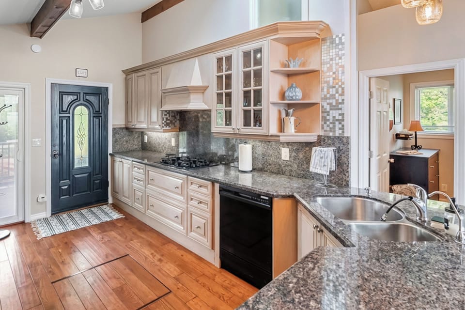A spacious kitchen featuring gas cooktop, granite countertops, and quality cabinetry. Perfect for entertaining and elevated cottage travel.