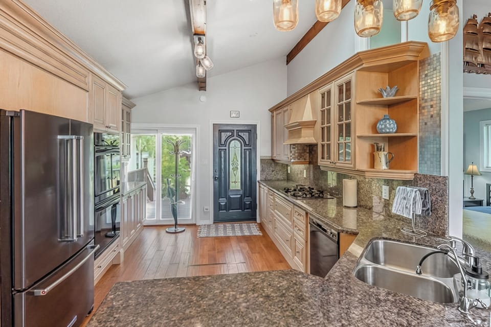 A welcoming kitchen and entry with natural light and quality finishes. Designed for seamless arrivals and comfortable vacation living.