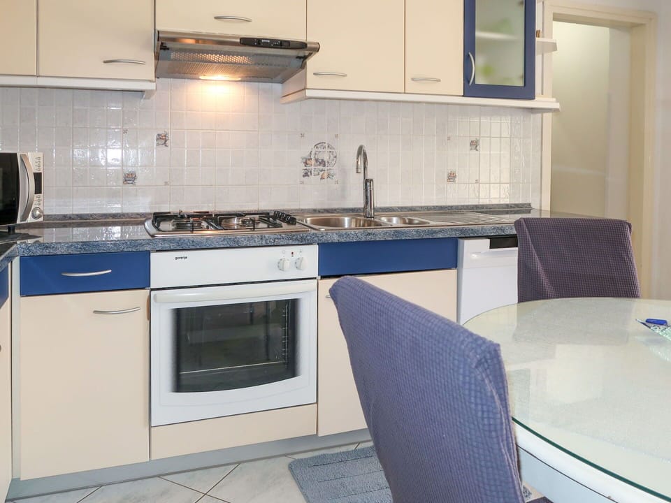 Kitchen, Kitchen Appliance, Countertop, Major Appliance, Flooring, Cabinetry, Kitchen Stove, Stove, Furniture, Interior Design