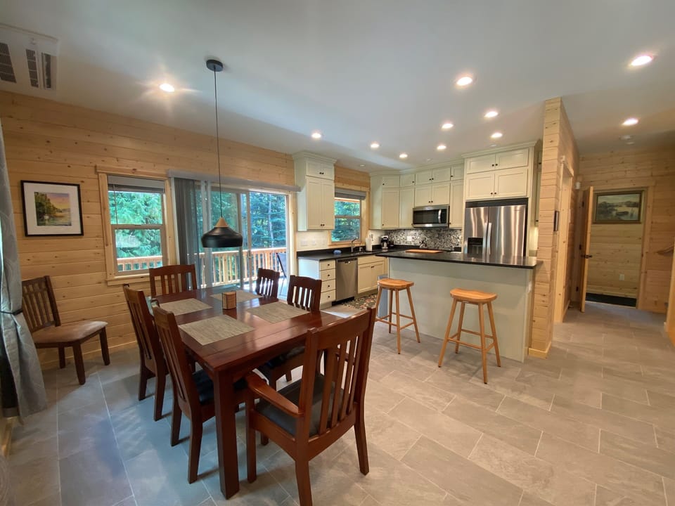Indoor/Outdoor dining in this bright and open dining area with slider leading to deck with additional tables and seating.
