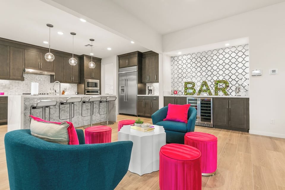 Pull up a stool at the custom bar area stocked with wine coolers and LED lighting.