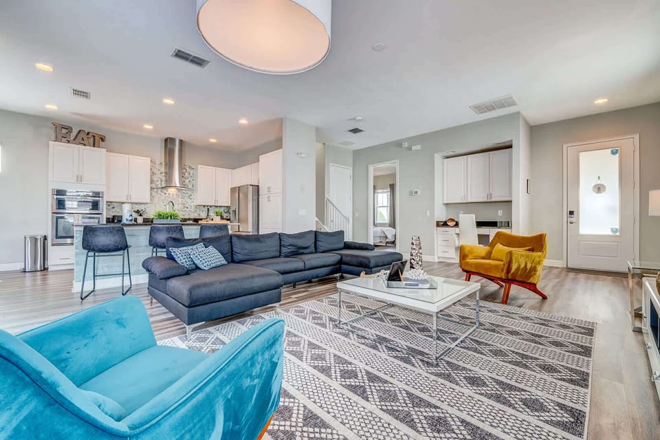 Open-concept living area with modern furnishings and a spacious kitchen.