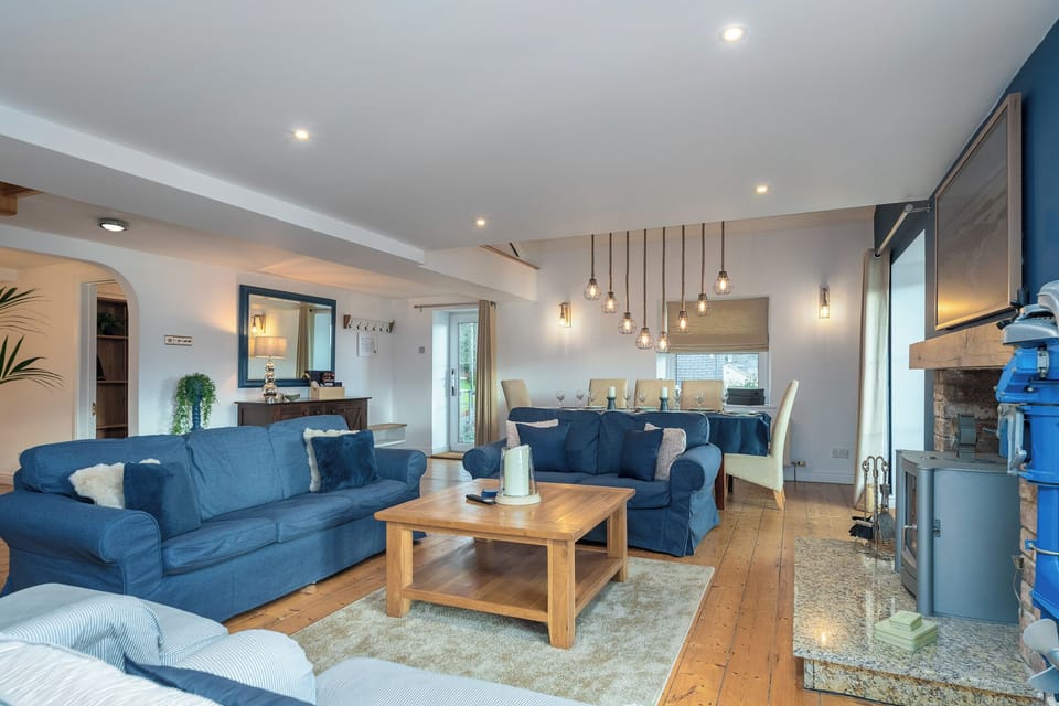 The large spacious living room with the log burning stove and dining area.