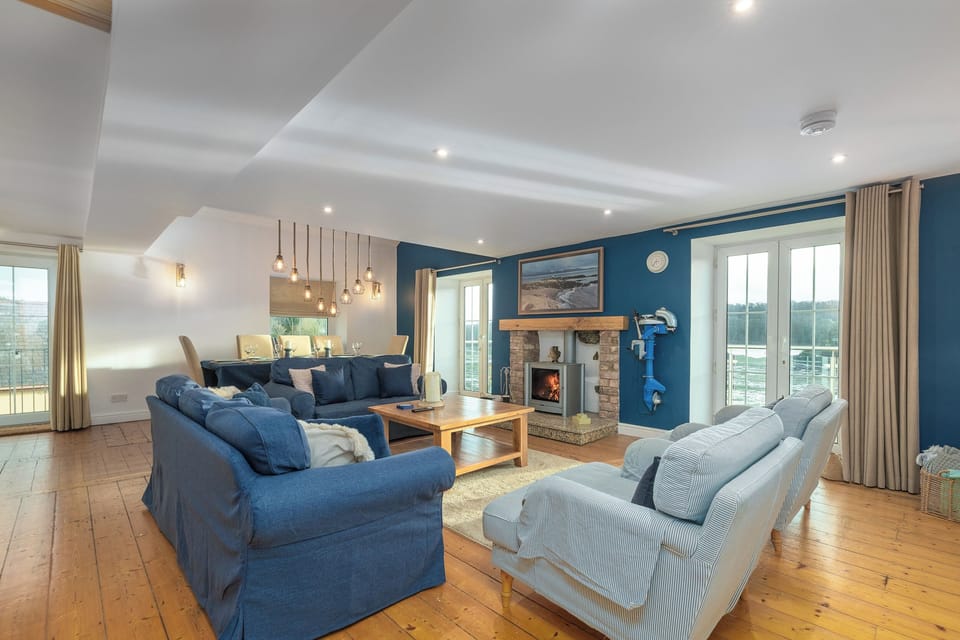 The large spacious living room with the log burning stove and dining area.