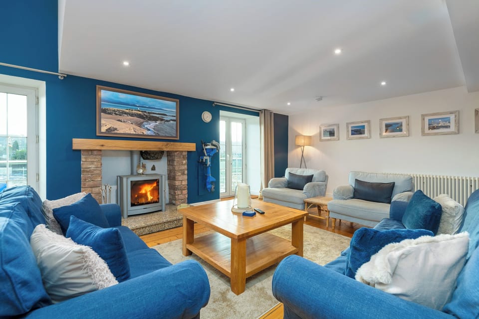 The large spacious living room with the log burning stove.