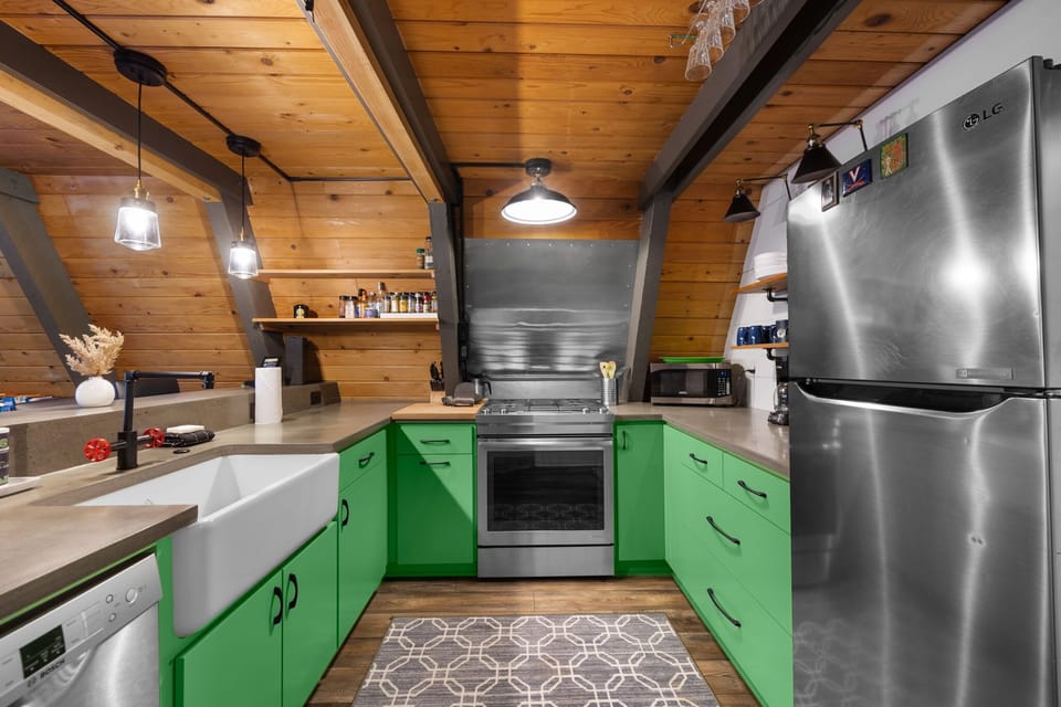 
Craft culinary delights in your modern kitchen. Stainless steel appliances and a farmhouse sink make cooking a joy after a day on the mountain.