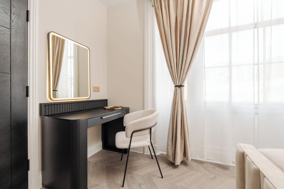 The dressing table doubles as both a vanity and a handy desk, giving you a comfortable space for getting ready or working remotely during your stay.
