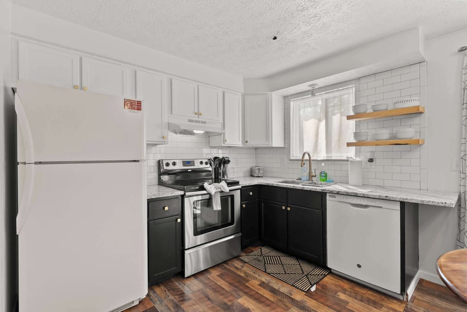 The sleek eat-in kitchen offers ample space & all the comforts of home​
