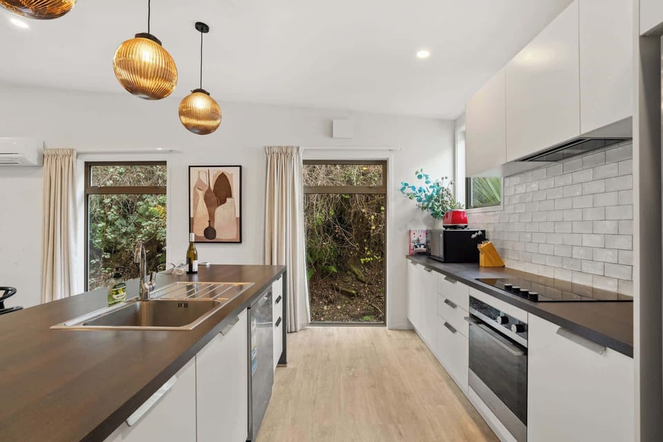 Fully equipped kitchen with modern appliances and garden views
