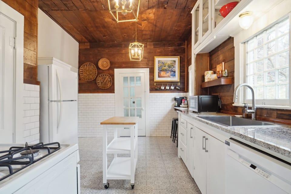Bright and spacious kitchen with sleek countertops and ample storage. 