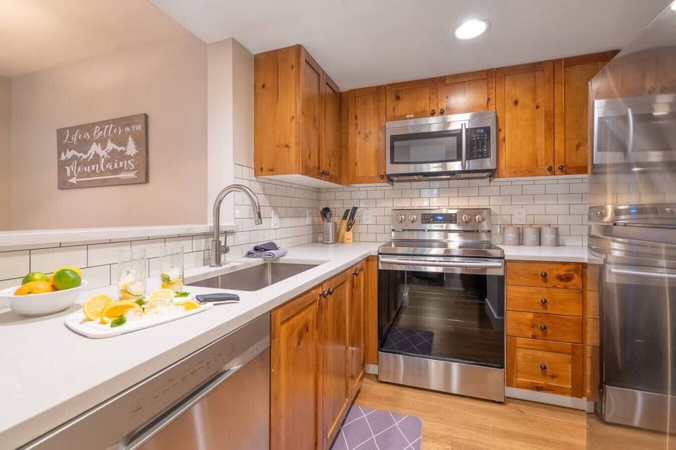 Fully stocked kitchen with granite counters, stainless appliances and induction cooktop.