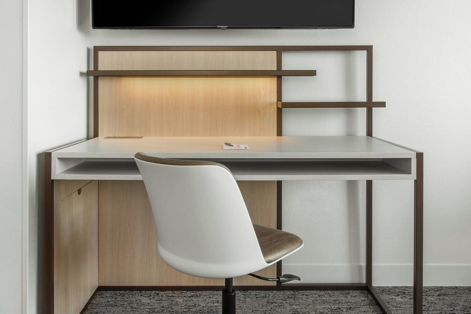 Desk, laptop workspace, iron/ironing board, travel crib