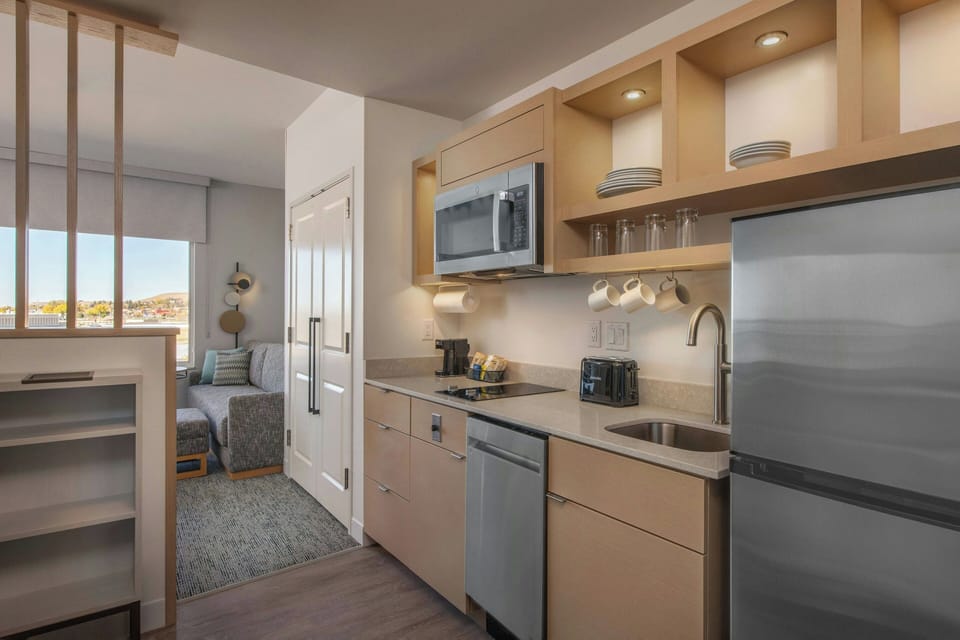 Suite, 1 Bedroom, Balcony, River View | Desk, laptop workspace, iron/ironing board, travel crib