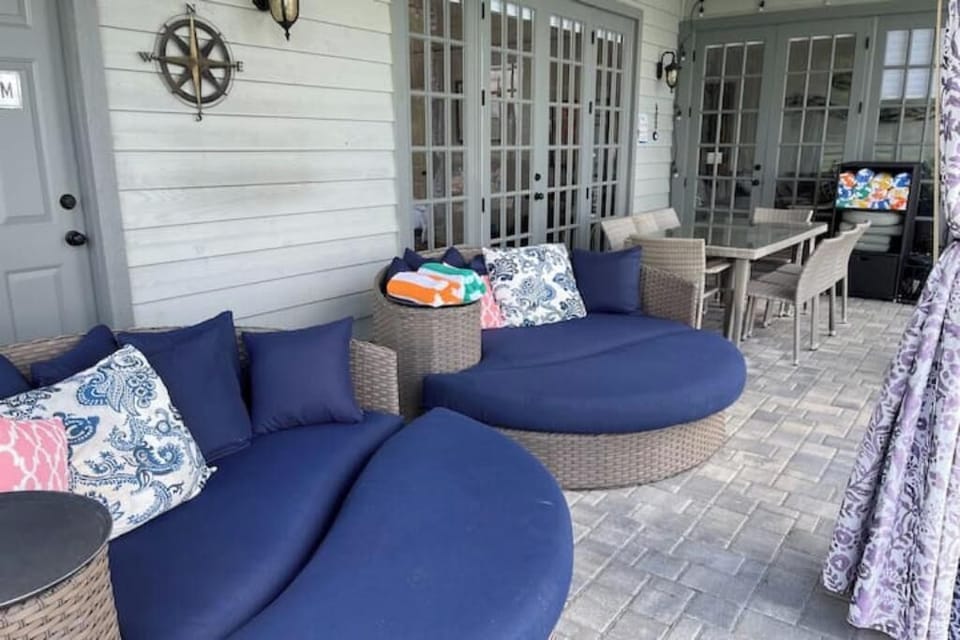 The pool deck w' dining table for 8. Two xl patio daybeds are great for lounging