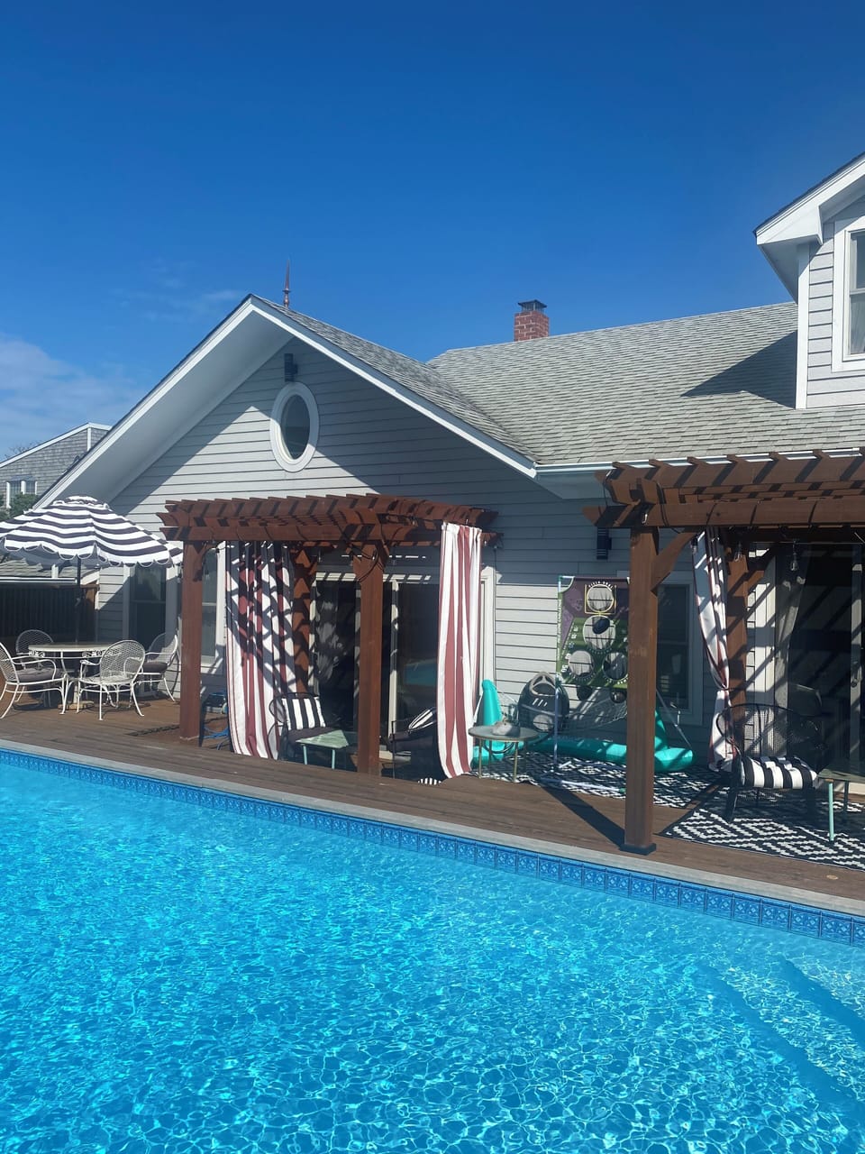 Pergolas line the pool for stylish shade. 