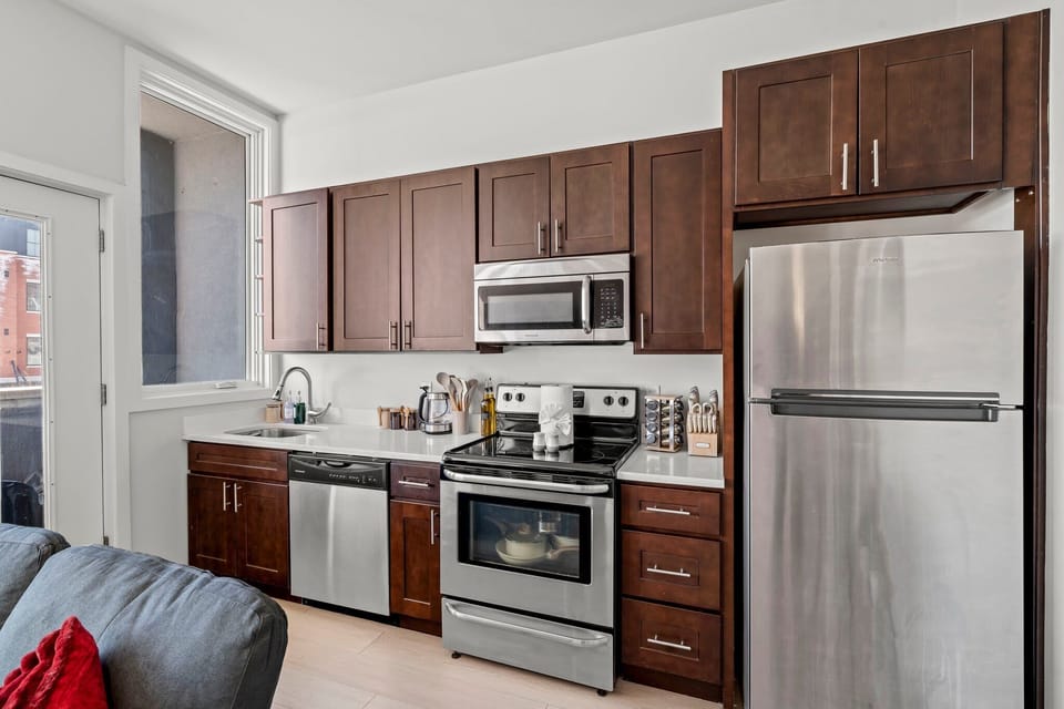 A fully equipped kitchen with stainless-steel appliances — ideal for home-cooked meals and extended stays.