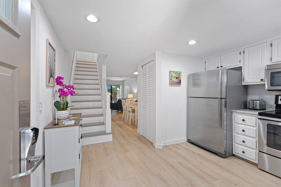 The bright, welcoming entryway opens to beautifully updated interiors featuring coastal-inspired finishes.