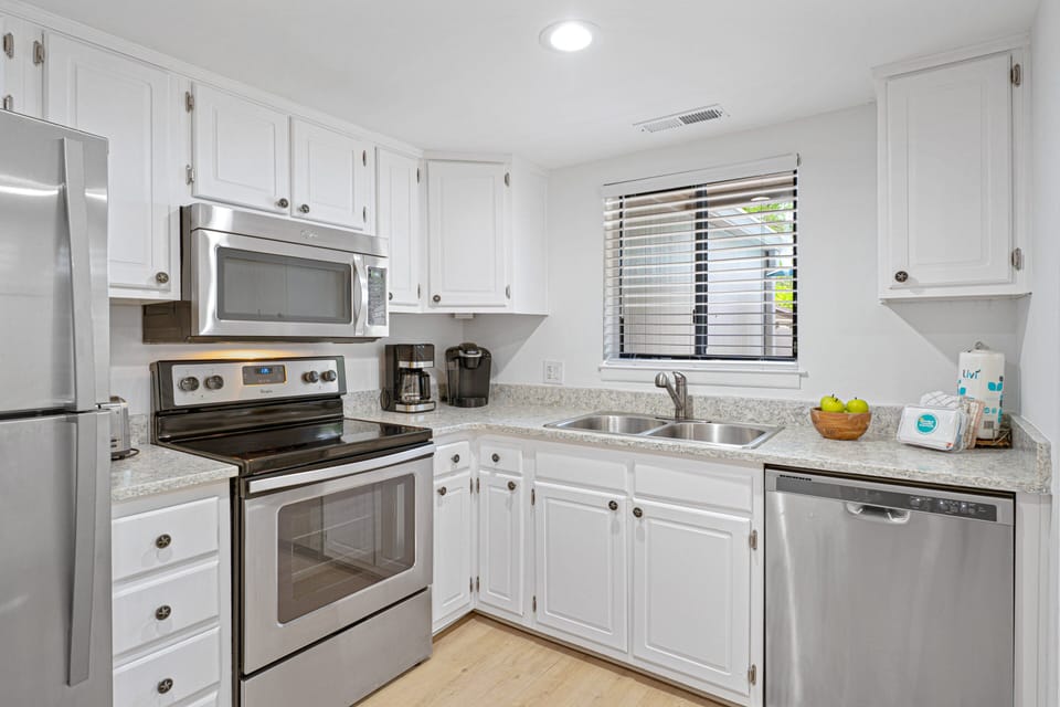 Stainless steel appliances, generous counter space, and ample cabinet storage provide all the essentials needed for a comfortable stay.
