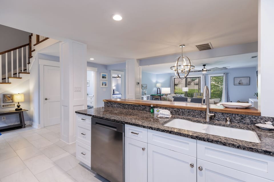 Bright and spacious kitchen with granite countertops and open living area.