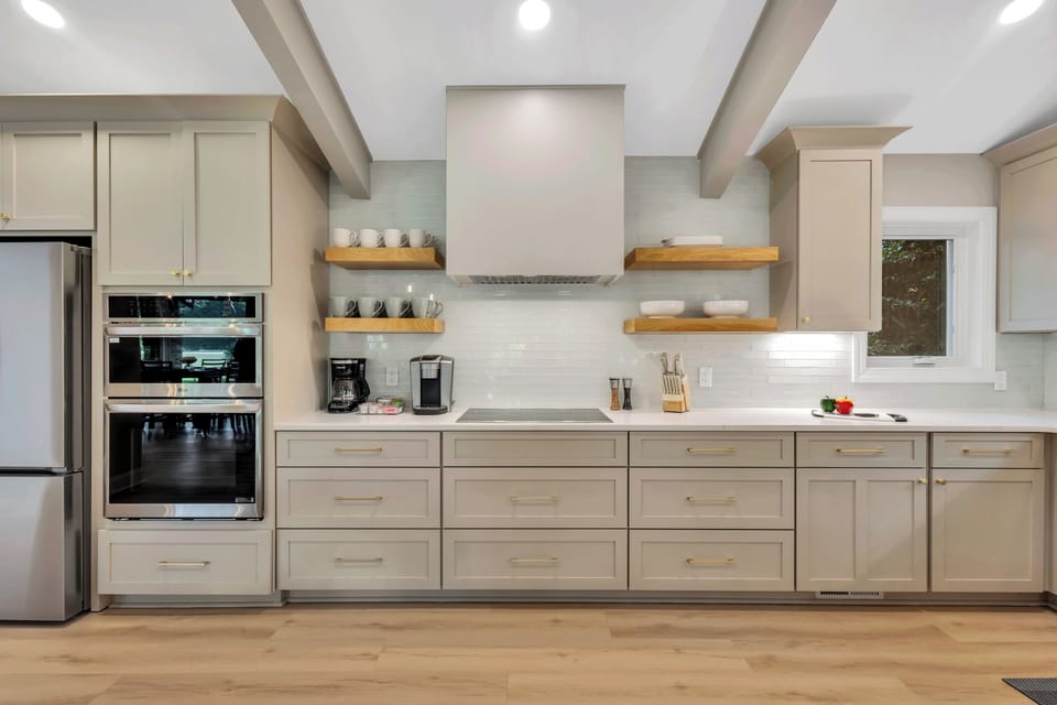 It features sleek appliances, ample counter space, a kitchen island with additional seating, and all the essentials for home chefs