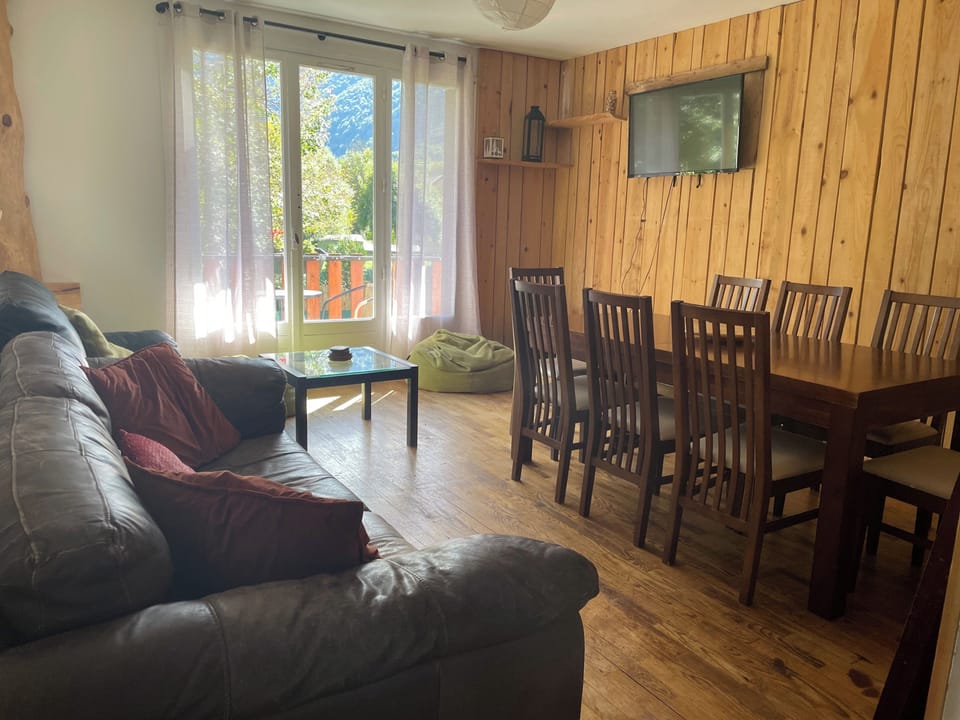 Sitting room and dining area for 8, with large French doors to balcony and view of mountains
