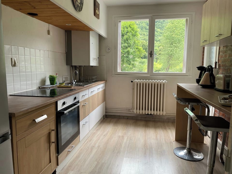Kitchen area with small balcony and view of mountains