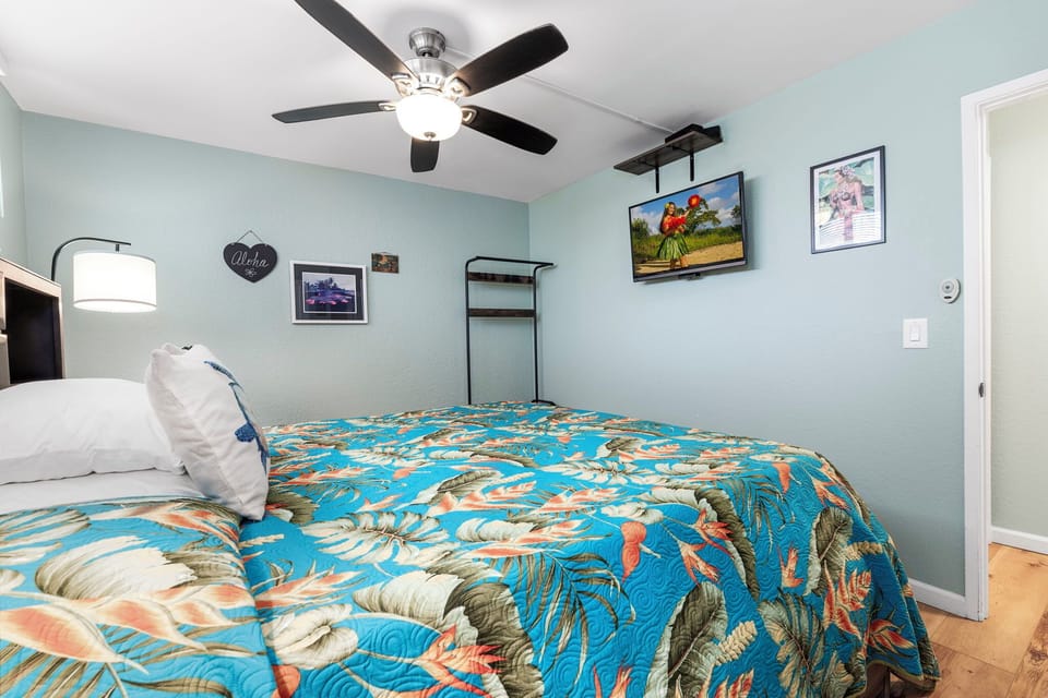 Rest comfortably in the inviting bedroom featuring a plush bed, fresh linens, ample storage, and quiet A/C for a restful night's sleep.