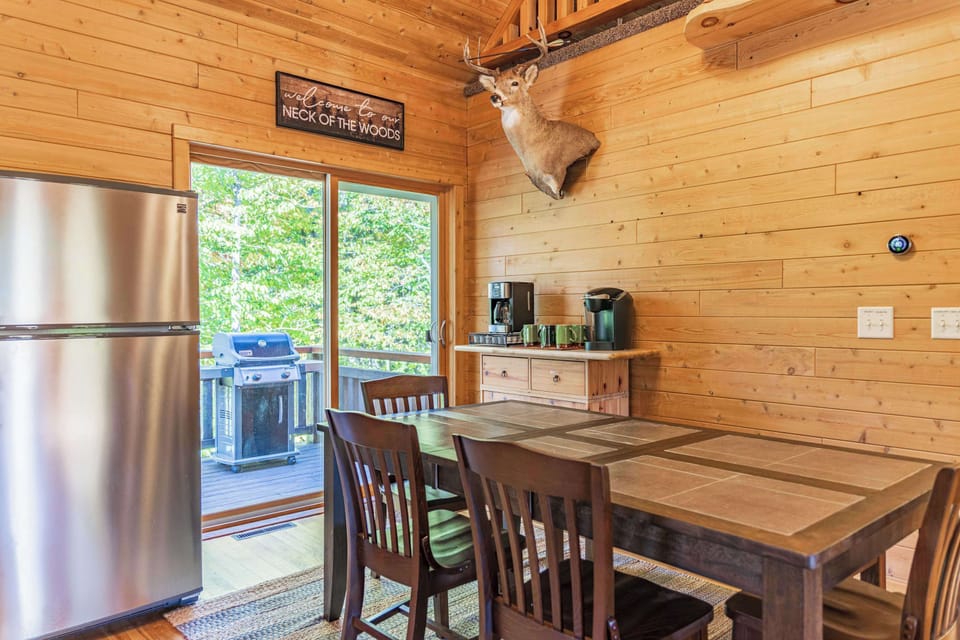 Dining area with seating for the group, sliding door access to the deck, and that classic UP cabin character