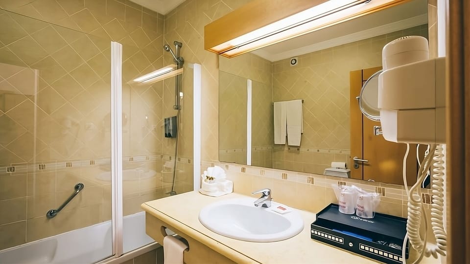 Get ready smoothly with a wide mirror and well-lit counter.