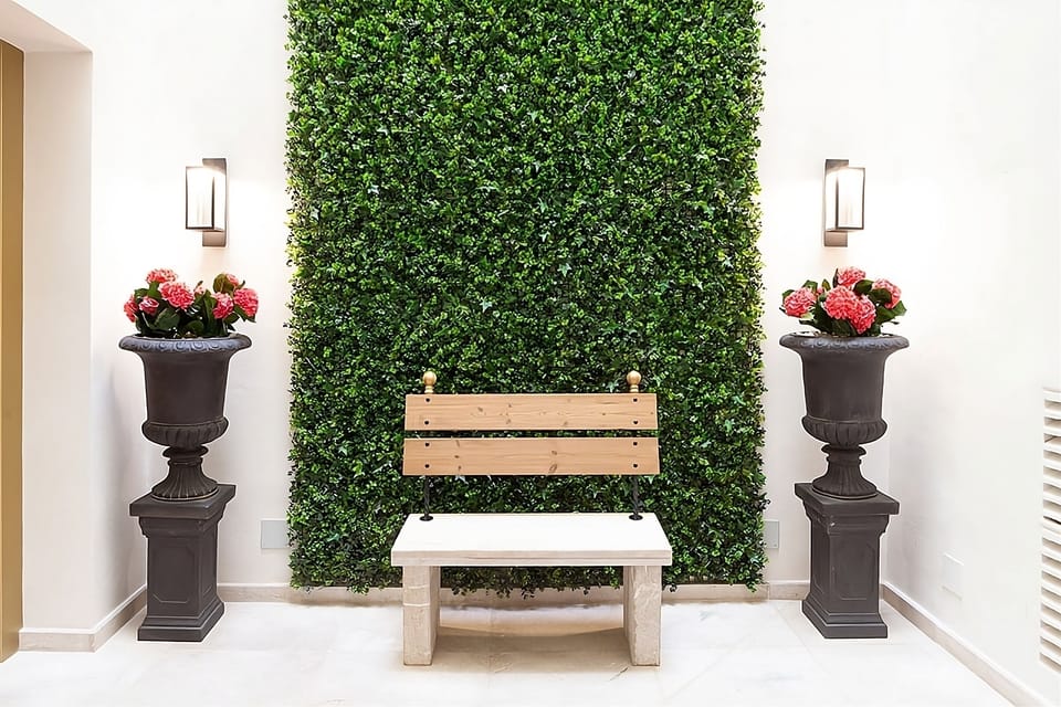 Pause for a calm moment beside greenery in a bright courtyard.