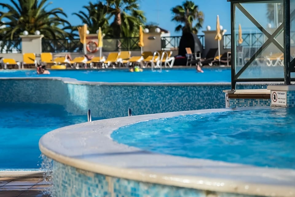 Cool off in the calm water as palms sway nearby.