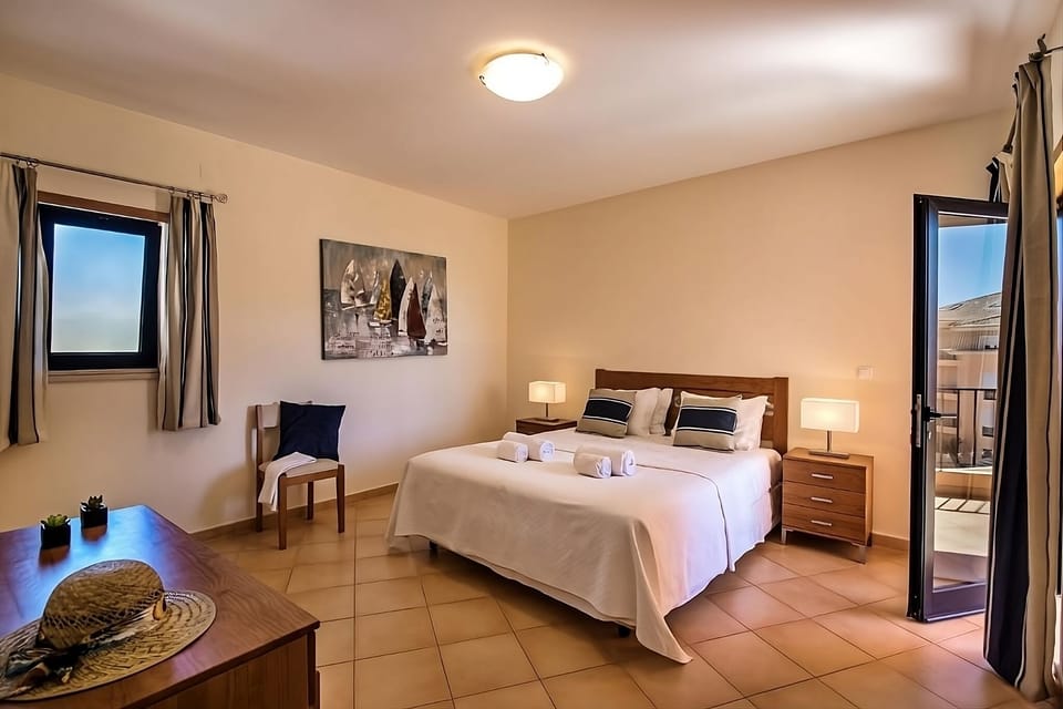 Unwind in a serene king bedroom with soft lighting.