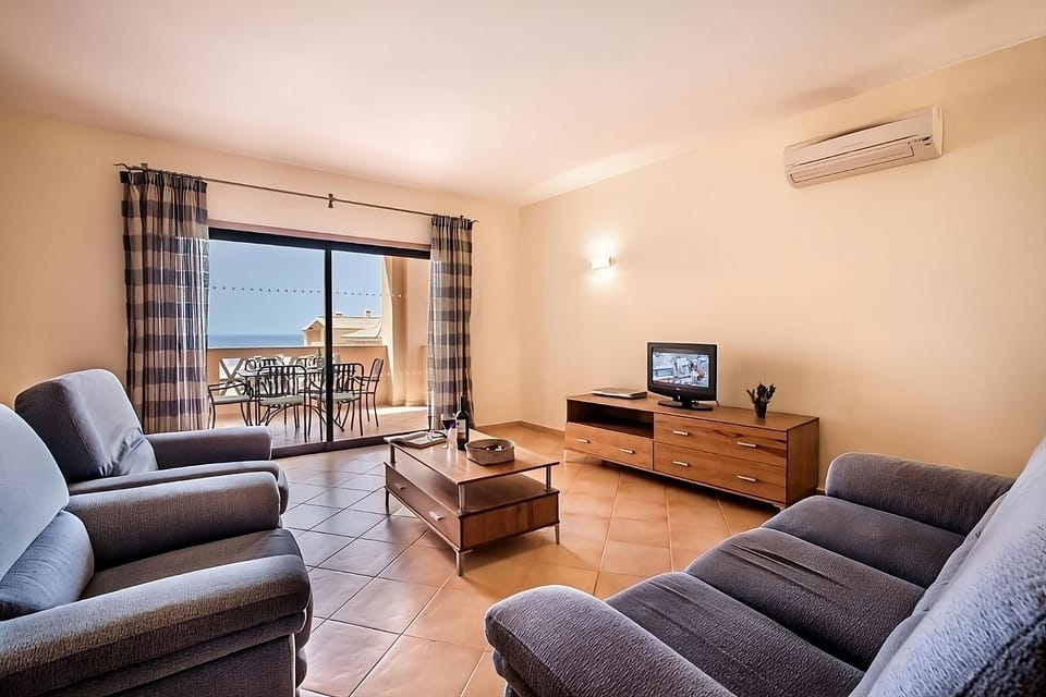 Unwind on plush sofas with fresh sea-breeze balcony views.