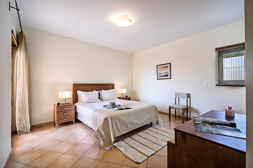 Drift off on crisp white bedding in a tranquil room.
