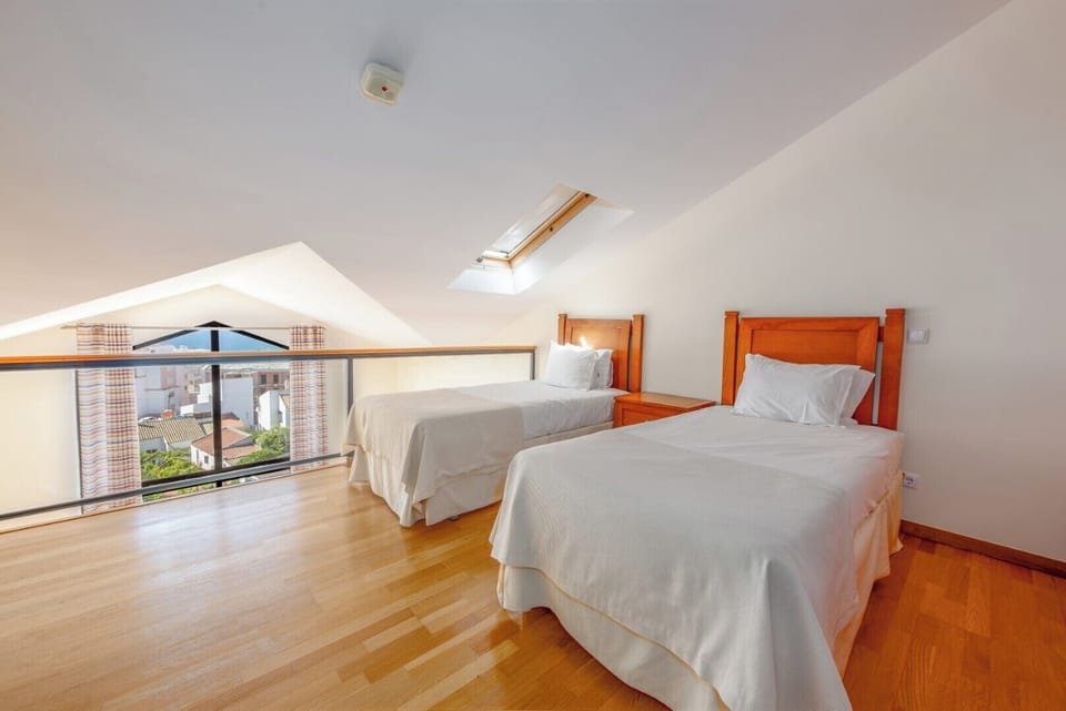 Wake up to sunshine and neighborhood views from twin beds.