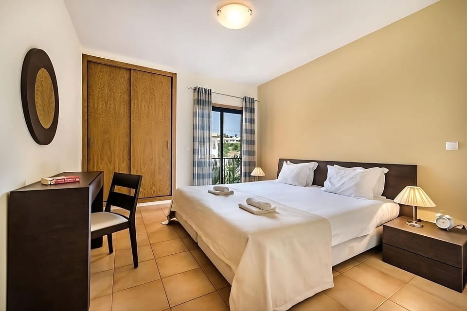 Unwind in a serene bedroom with balcony views and soft linens.