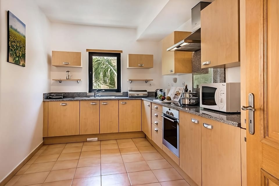 Cook effortlessly in the fully equipped kitchen with balcony access.