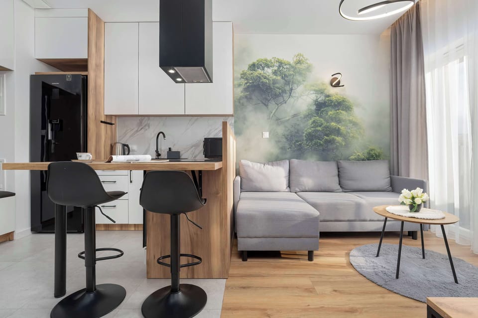 The bright interior with a modern breakfast bar and spot lighting offers a space for both work and shared meals.