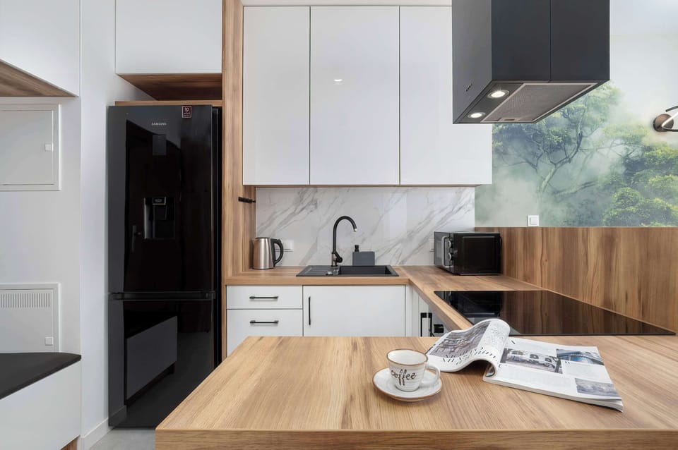 The ergonomically designed kitchen with a wooden countertop and modern appliances makes cooking comfortable, even for short stays.