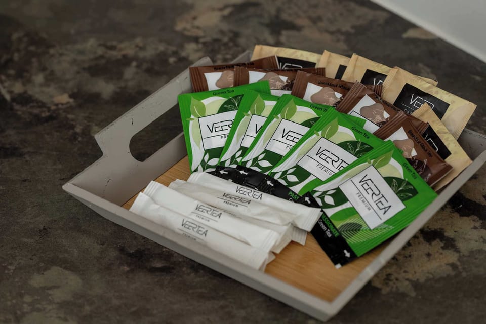A selection of teas, coffees, and sweets awaits guests, offering a warm welcome and a relaxing treat after arrival.

