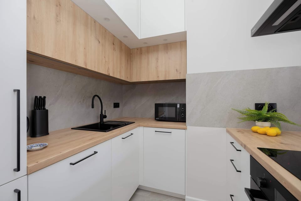 The wooden accents in the kitchen bring warmth to the interior, while the thoughtful layout allows for easy cooking.