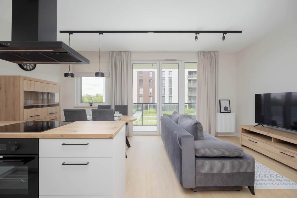 The open kitchen with an island and view of the living room creates a modern yet homey space perfect for cooking and spending time together.