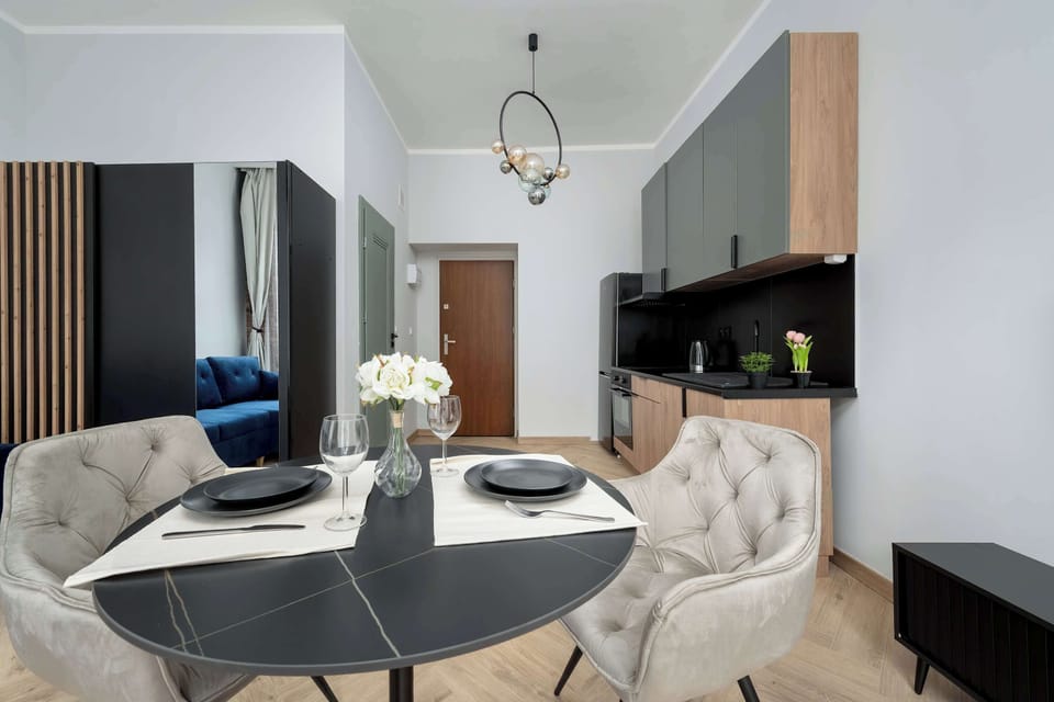 The dining corner connected to the living room offers an elegant space for shared meals, with comfortable chairs and atmospheric lighting.