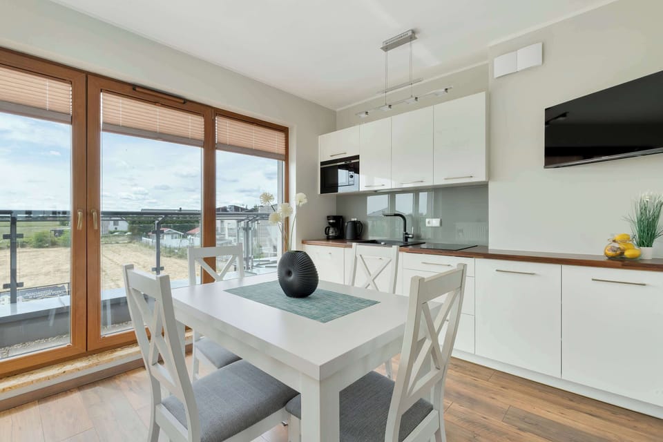 The dining nook overlooking greenery invites guests to enjoy shared meals and conversation.