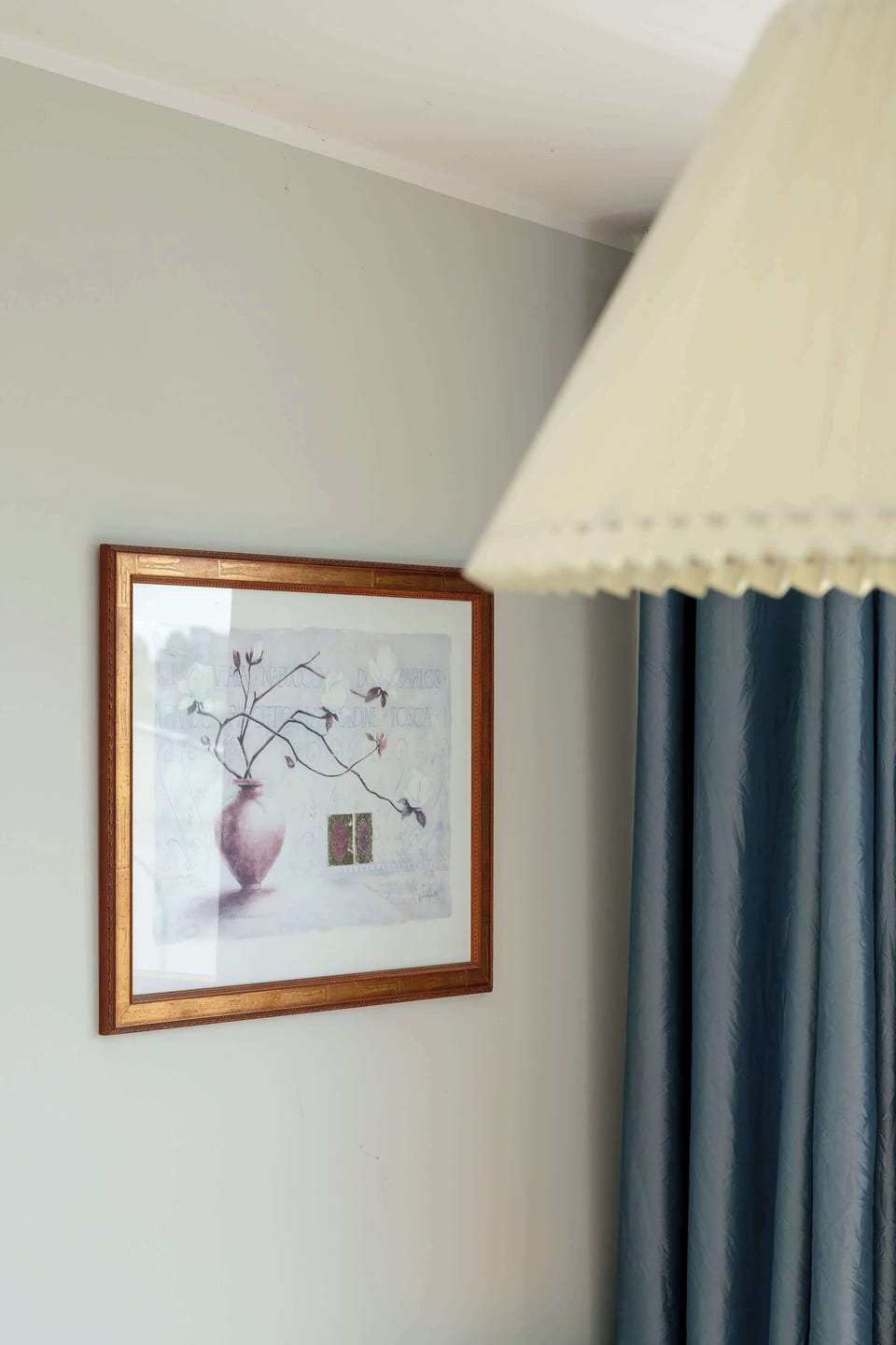 The detail shot of the curtain and artwork highlights the attention to aesthetics and cozy ambiance.

