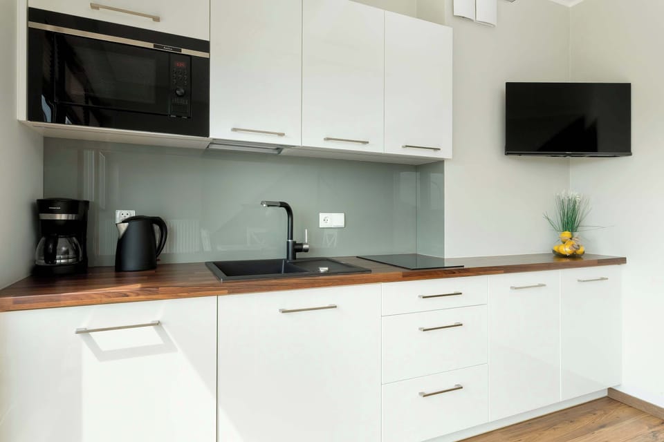 The fully equipped kitchen, including a coffee maker and microwave, allows for convenient meal preparation.

