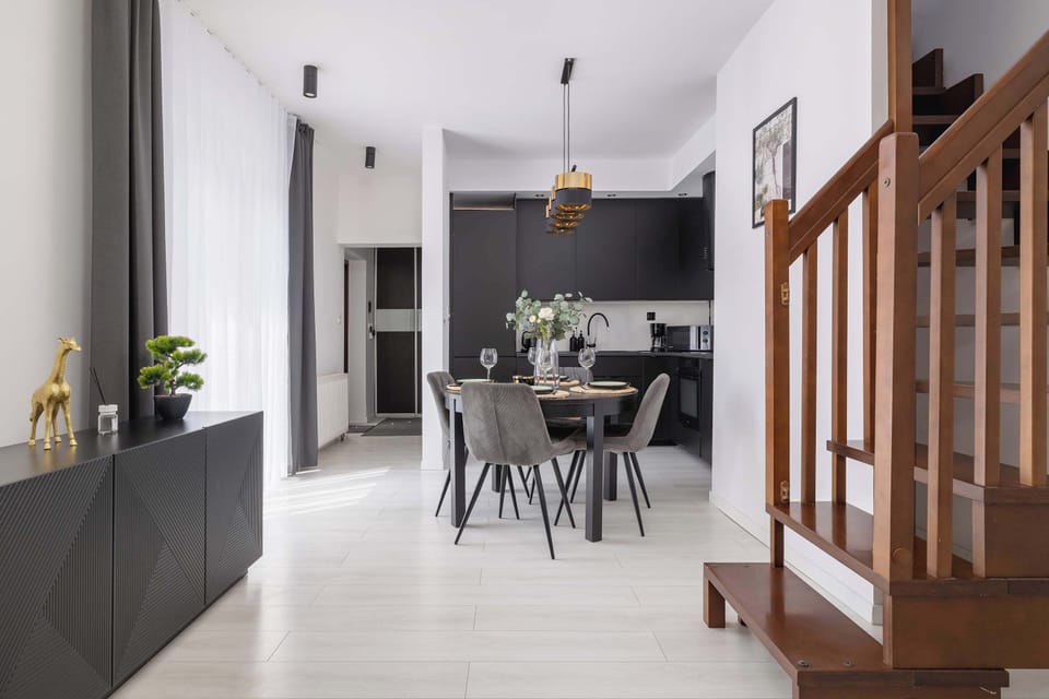 A dining area with designer chairs and striking lighting is the perfect place for shared meals.