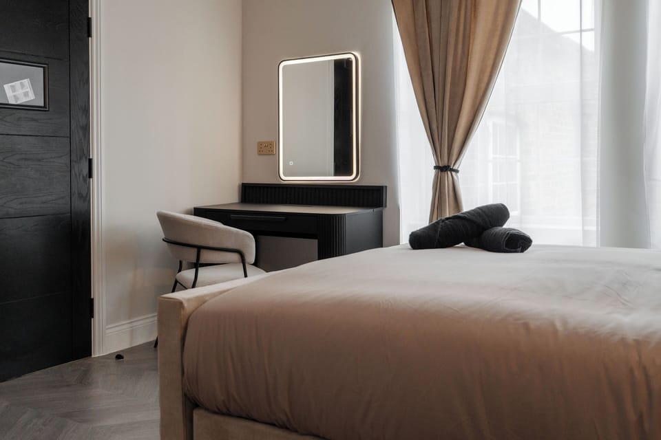 A dedicated vanity desk with mirror, perfect for make-up, getting ready, or setting up a small workspace during your stay.
