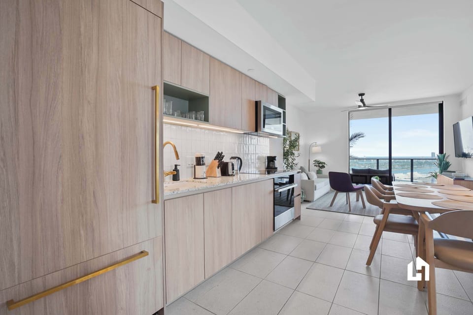 Modern kitchen connected to a dining area with stunning bay views.