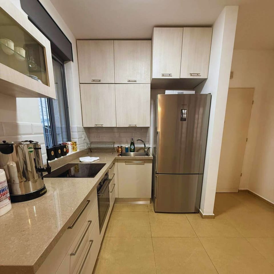 Open-plan layout with the kitchen and dining area seamlessly connected, creating a spacious and inviting atmosphere for cooking and enjoying meals together.